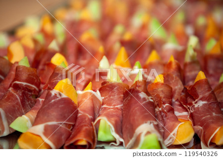 Savor the flavor of these exquisite Prosciutto Wrapped Melon Bites for your elegant catering needs Savor the flavor of these exquisite Prosciutto Wrapped Melon Bites for your elegant catering needs 119540326