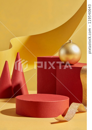 The template photo showcases a Christmas concept with red circular platforms, for displaying products, a cone, and rectangular platforms decorated with yellow paper and ribbon. 119540643