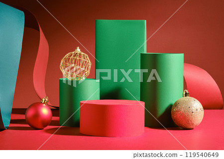 Green rectangles, two green cylinder platforms, Christmas balls, a red paper strip, and a green paper plate surround the vacant red cylinder platform. An example picture of Christmas merchandise. Green rectangles, two green cylinder platforms, Christmas balls, a red paper strip, and a green paper plate surround the vacant red cylinder platform. An example picture of Christmas merchandise. 119540649