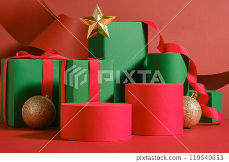 A template image with front view of a Christmas decoration concept, with accessories and empty podiums displayed on a red background, for advertising with blank space for presentation products. A template image with front view of a Christmas decoration concept, with accessories and empty podiums displayed on a red background, for advertising with blank space for presentation products. 119540653