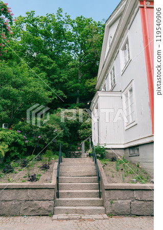 A house with stairs surrounded by greenery 119540906