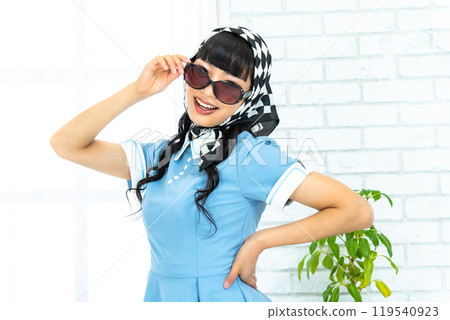 A woman in Showa retro fashion wearing sunglasses A woman in Showa retro fashion wearing sunglasses 119540923