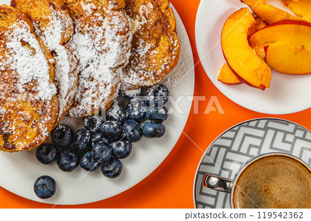 French toast on a plate with blueberries, orange juice, nectarine for breakfast 119542362