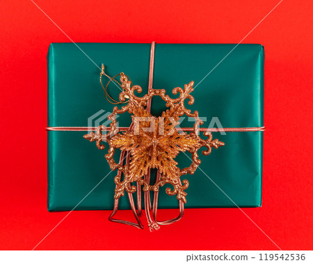 Dark green Christmas gift box with gold star decoration Dark green Christmas gift box with gold star decoration 119542536