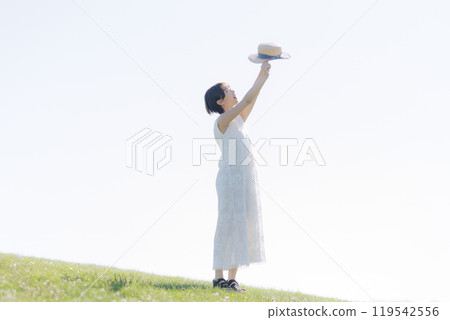Young woman standing on a hill 119542556