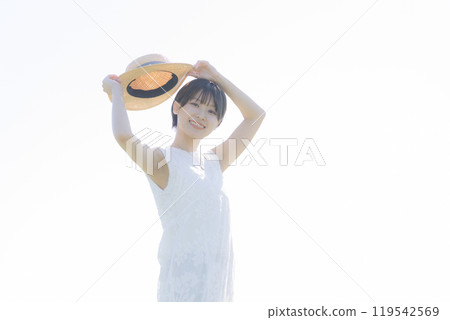 Young woman standing on a hill 119542569