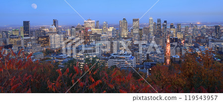New skyline of Montreal illuminated at dusk in autumn with red leaves in the foreground Quebec, Canada New skyline of Montreal illuminated at dusk in autumn with red leaves in the foreground Quebec, Canada 119543957