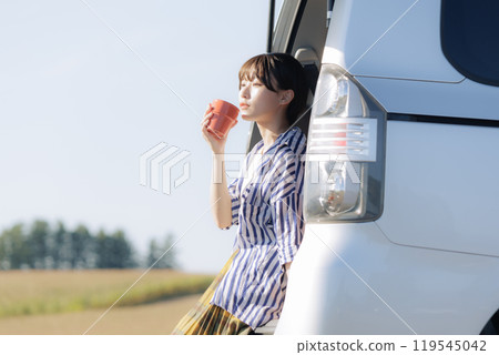 Young woman relaxing sitting in a trunk Young woman relaxing sitting in a trunk 119545042