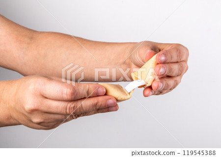 Fortune cookies in hand on a light background Fortune cookies in hand on a light background 119545388