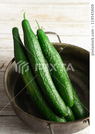 fresh cucumbers in a black bowl 119545609