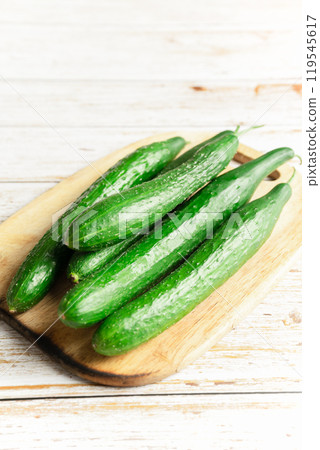 fresh cucumbers on a wooden board 119545617