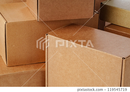 A close view of multiple brown cardboard boxes stacked closely in a warehouse 119545719