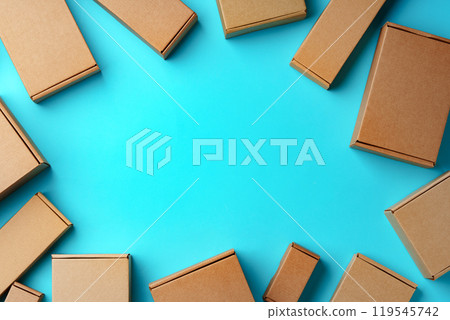 A collection of cardboard boxes arranged on a bright blue surface A collection of cardboard boxes arranged on a bright blue surface 119545742