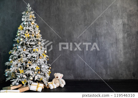 Snow Christmas tree with gifts in the interior of a decorated gray room 119546310