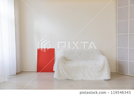 White sofa in the interior of a white room with a window White sofa in the interior of a white room with a window 119546343