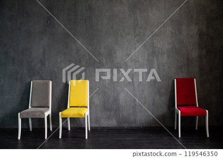 Three chairs in the interior of gray room Three chairs in the interior of gray room 119546350