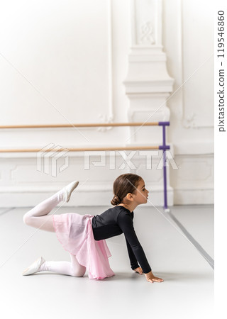 Little girl doing gymnastics exercising warming up before ballet dance workout 119546860