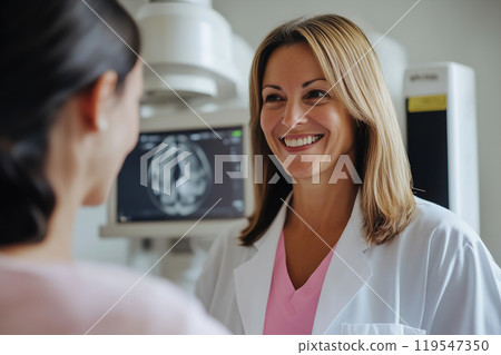 Smiling female doctor discusses MRI results with patient in a modern medical office during a routine 119547350