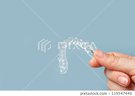Transparent Dental Clear Aligners on Blue. Invisible Braces. Prevention Gums Treatment. Retainers for Dentistry Correction. Invisalign Orthodontics concept. Alignment of Teeth. Dentofacial Orthopedics 119547440