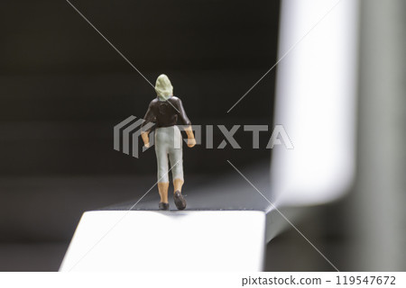 A female doll in a business suit standing in front of an uphill slope Image of life and career A female doll in a business suit standing in front of an uphill slope Image of life and career 119547672