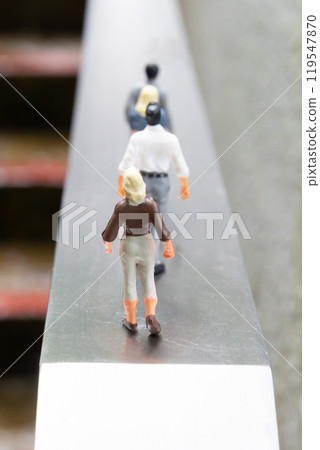 Male and female dolls standing in a row on a road - Image of life and career Male and female dolls standing in a row on a road - Image of life and career 119547870