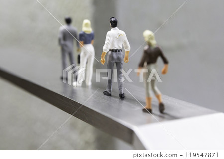 Male and female dolls standing in a row on a road - Image of life and career Male and female dolls standing in a row on a road - Image of life and career 119547871