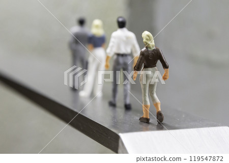 Male and female dolls standing in a row on a road - Image of life and career Male and female dolls standing in a row on a road - Image of life and career 119547872