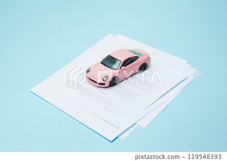 Pink Car Model on contract paper documents stack. Car insurance concept, car sale, Car loan application. Business Transaction for Buying, Selling, Leasing, Insuring a New or Used Vehicle. Choose auto 119548393