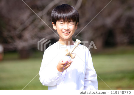 A boy practicing Kendama 119548770