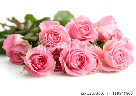 A bouquet of vibrant pink roses arranged elegantly with lush green leaves on a white background 119548806