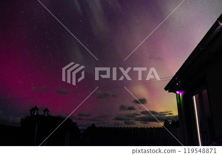 The Aurora Borealis, the northern lights, showing up above bungalow in County Donegal, Ireland 119548871