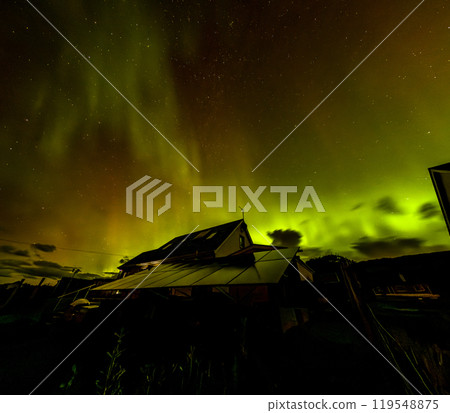 The Aurora Borealis, the northern lights, showing up above bungalow in County Donegal, Ireland 119548875