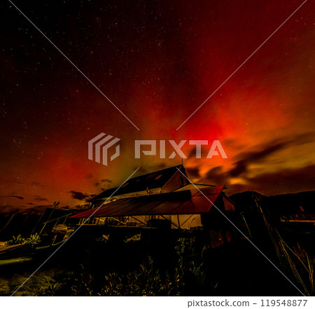 The Aurora Borealis, the northern lights, showing up above bungalow in County Donegal, Ireland The Aurora Borealis, the northern lights, showing up above bungalow in County Donegal, Ireland 119548877