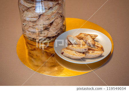 Almond cantucci arranged on plate show crisp texture and nutty flavor with jar of cookies behind Almond cantucci arranged on plate show crisp texture and nutty flavor with jar of cookies behind 119549034