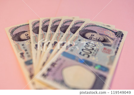 Fanned out 5000 yen bills on soft pink backdrop show detailed design, portrait of Japanese currency 119549049