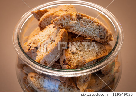 A top view of Italian almond biscotti stored in a glass jar 119549056