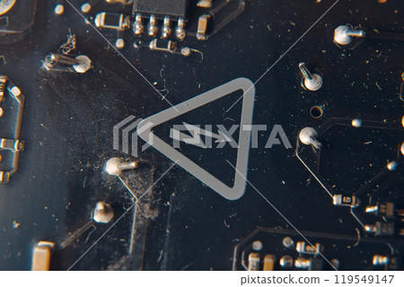 A detailed view showcasing a vibrant circuit board that prominently features a warning symbol indicating electricity A detailed view showcasing a vibrant circuit board that prominently features a warning symbol indicating electricity 119549147