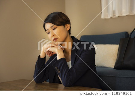 A businesswoman worried in the living room at night A businesswoman worried in the living room at night 119549161