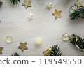 Festive background with Christmas branches and lights with copy space. White wooden table stars 119549550