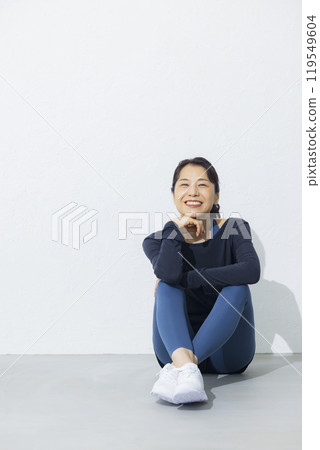 A woman in her 50s stretching A woman in her 50s stretching 119549604