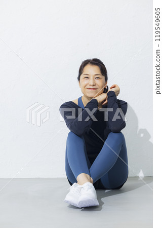 A woman in her 50s stretching A woman in her 50s stretching 119549605
