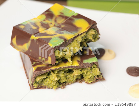 Dubai chocolate bar with pistachio paste and kataifi dough. Confectionery and sweets. Dubai chocolate bar with pistachio paste and kataifi dough. Confectionery and sweets. 119549887