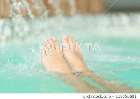 Feet with pedicure floating in spa 119550691