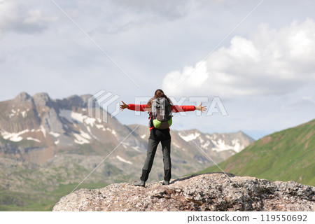 Hiker celebrating success in the top of a mountain 119550692
