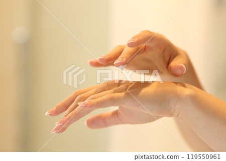 Woman hands applying moisturizer cream in the bathroom Woman hands applying moisturizer cream in the bathroom 119550961