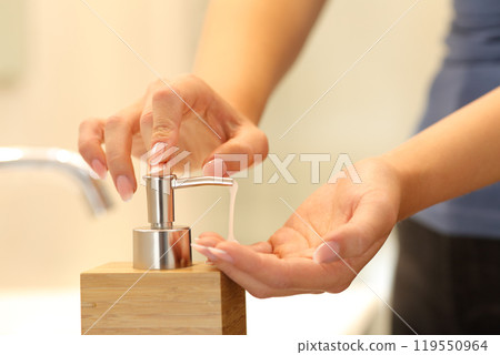 Woman hands applying soap ready to wash 119550964