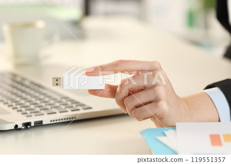 Business woman hand showing pendrive stick Business woman hand showing pendrive stick 119551357