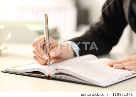 Executive woman hands writing notes on agenda Executive woman hands writing notes on agenda 119551378