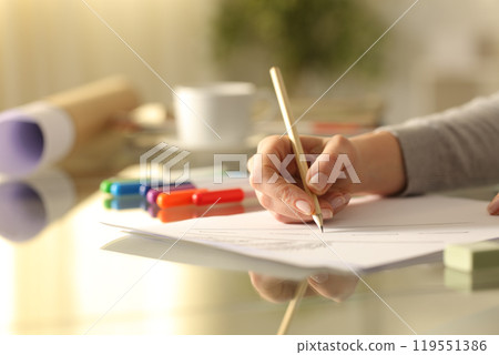 Designer woman drawing sketch with pencil on a desk Designer woman drawing sketch with pencil on a desk 119551386