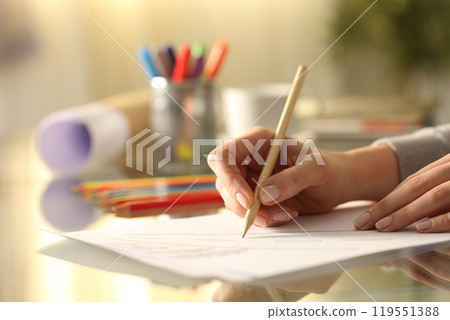 Designer woman sketching drawing with pencil on desk Designer woman sketching drawing with pencil on desk 119551388